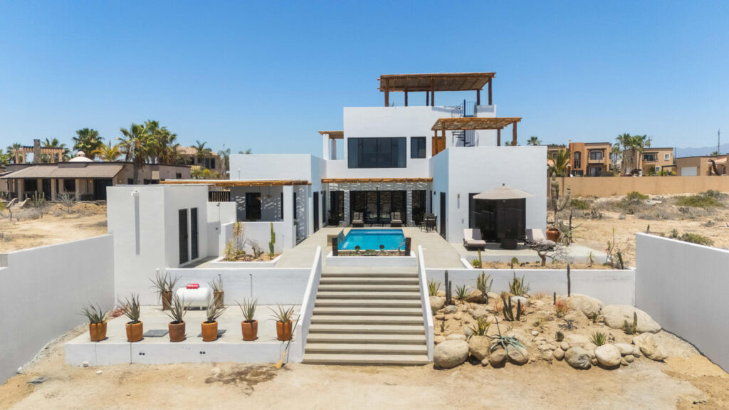 Los Cabos El Posito We are excited to introduce Casa Elisabeth, an amazing, newly constructed custom home in the private El Posito area of Todos Santos. Located just three rows back from the beach, this three-bedroom, three-full and two-half bathroom residence offers every amenity desired for a tropical paradise. The downstairs features an open-concept living room, dining room, and a fully stocked kitchen with brand-new appliances, including a dishwasher. The main floor also includes a laundry room and an outdoor water feature with a professionally designed rock wall. The principal bedroom downstairs offers a unique indoor/outdoor bathroom with two showers and an outdoor bathtub.Each of the three bedrooms includes an en-suite bathroom with double vanities. The upstairs bedroom features its own private furnished terrace and access to one of four large patios, complete with a bar area and outdoor furniture perfect for enjoying ocean sunsets. Additionally, a shaded third-floor observation deck provides panoramic ocean and mountain – Casa Elisabeth, Pacific, Pacific, BS